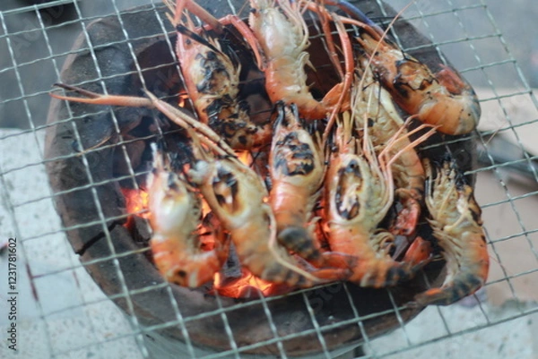 Obraz  Raw Shrimp on Grill with Charcoal Background
