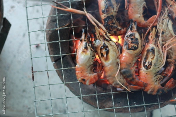 Obraz  Raw Shrimp on Grill with Charcoal Background