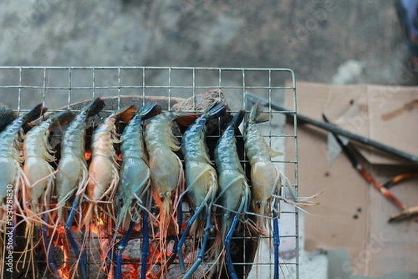 Obraz  Raw Shrimp on Grill with Charcoal Background