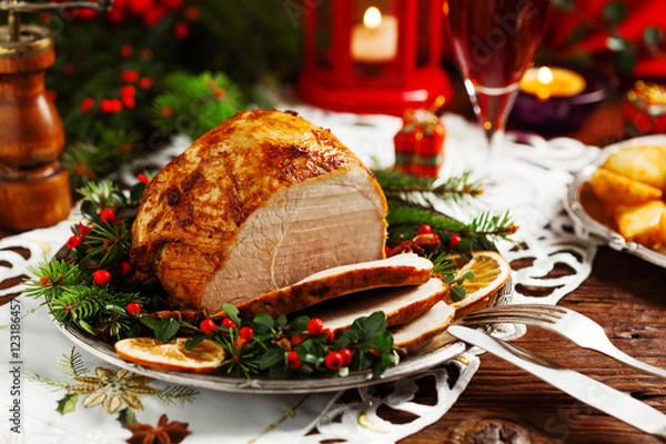 Fototapeta Christmas baked ham, served on the old plate.