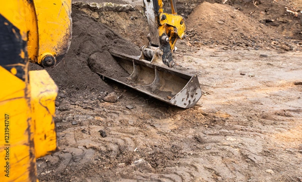 Obraz excavator on a construction site. Excavator digging earth for earthworks and construction. Heavy equipment for earthworks and construction