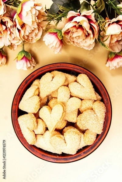 Fototapeta Cookies hearts and flowers on a beige background