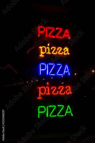 Fototapeta Colorful neon signs of pizza illuminated at night, Turin, Italy