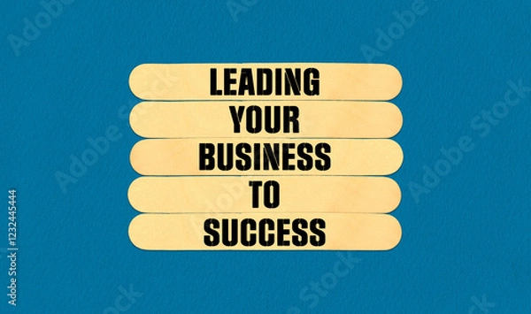 Fototapeta Concept word Leading Your Business To Success on beautiful wooden stick. Beautiful Blue Chart Paper Background. Business and Leading Your Business To Success concept.