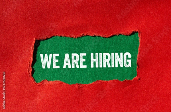 Fototapeta We are hiring message written on ripped torn red paper on green background. Conceptual we are hiring symbol. Copy space.
