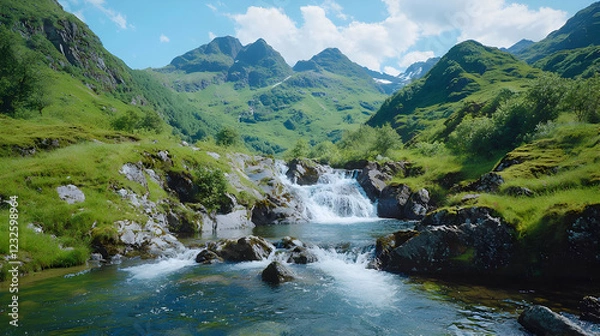 Fototapeta Mountain stream cascading through lush valley
