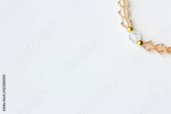 Obraz Clean and minimalist banner background with copy space and elegant bead strand in ambar color on right top corner. Ideal for delicate high end costume jewelry design.