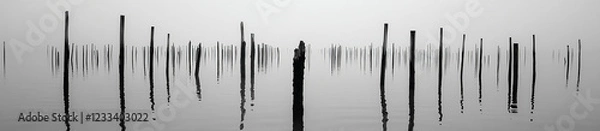 Fototapeta A flat surface of water, with ripples visible in the distance, against a white background. The focus is on the calmness and stillness of the sea's surface, capturing its serene beauty. 