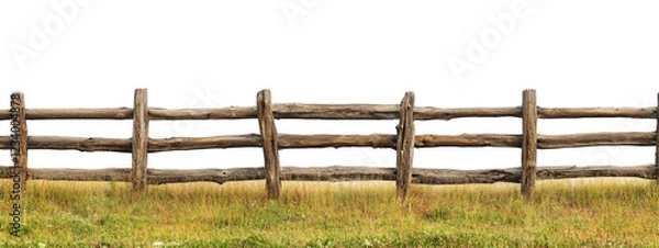 Fototapeta wooden split rail fence stretches across grassy field, showcasing rustic charm and natural beauty. This serene landscape evokes sense of tranquility and connection to nature