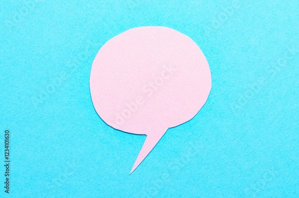 Obraz Pink cut out blank paper speech bubble of round shape with copy space for text on blue background, flat lay top view conceptual backdrop