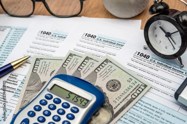 Fototapeta tax forms, calculator, pen dollar money on desk. View from above. Time for tax