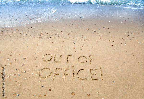 Fototapeta out of officek, written in the sand at the beach