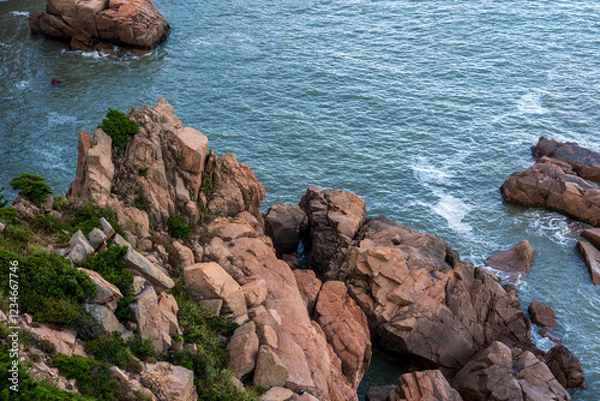 Fototapeta Serene Coastal View of Rocky Outcrops and Calm Waters