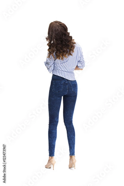 Fototapeta Young beautiful brunette woman in blue jeans