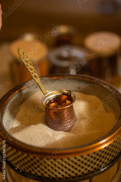 Obraz Preparation of Turkish coffee in the cezve in the sand.