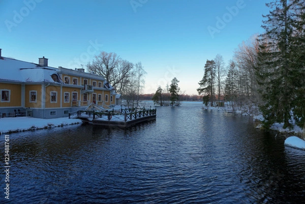 Obraz A old building at a lake during winter