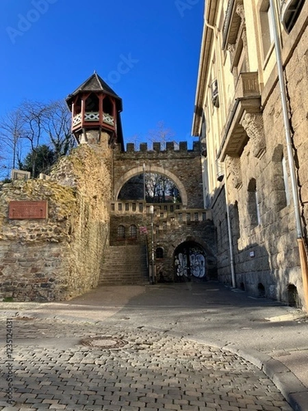 Fototapeta Medieval Stone Gateway with Tower and Cobblestone Path