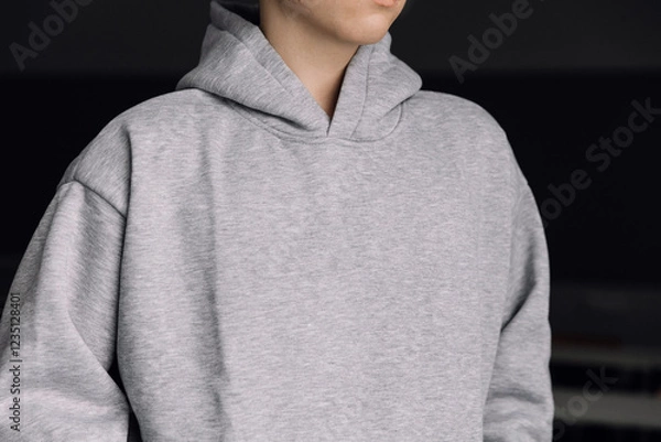 Fototapeta Gray hoodie on a man, chest-level shot without a face, horizontal photo