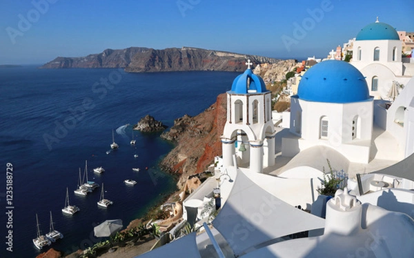 Fototapeta Oia Santorini's iconic blue-domed churches overlooking the island's volcanic caldera and the Mediterranean Sea	
