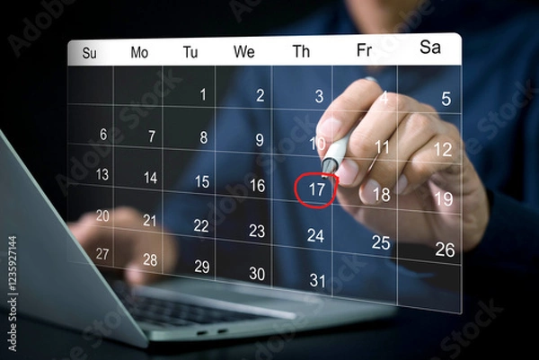 Fototapeta Businessman manages time for effective work. Calendar on the virtual screen interface, Businessman making red circles on important days on the calendar Important appointment dates
