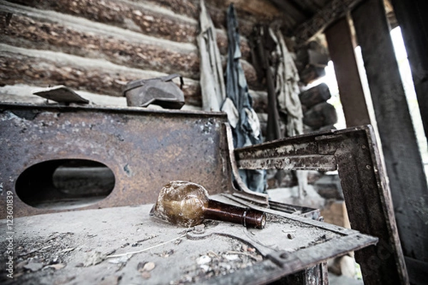 Obraz Broken Bottle on an antique stove