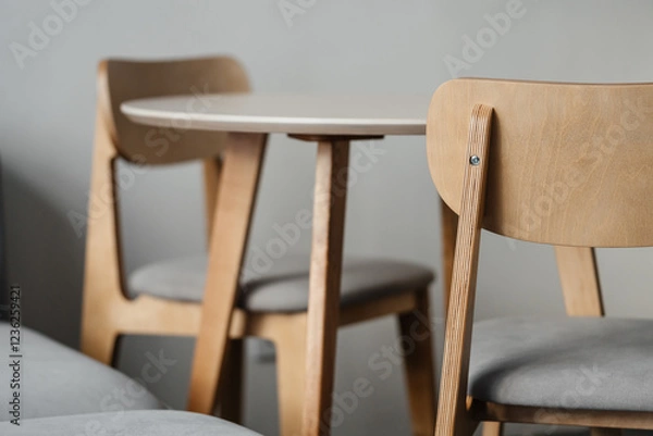 Fototapeta Plywood chair against the background of a table and a kitchen in defocus. Furniture and interior details of a modern.