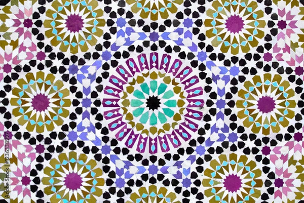 Fototapeta A detailed Islamic geometric mosaic featuring vibrant colors and symmetrical patterns. The design showcases traditional arabesque motifs with star shapes and interwoven lines