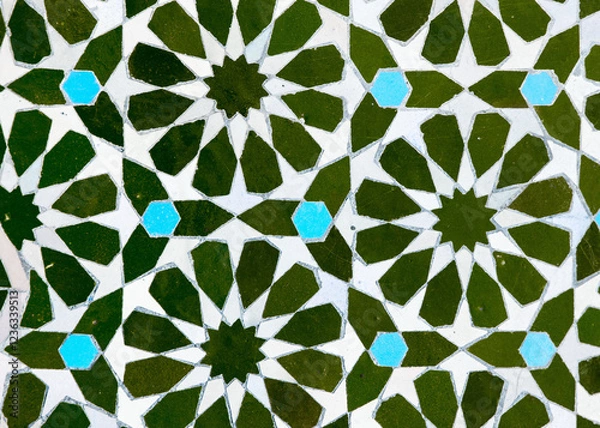 Fototapeta A detailed Islamic geometric mosaic featuring vibrant colors and symmetrical patterns. The design showcases traditional arabesque motifs with star shapes and interwoven lines