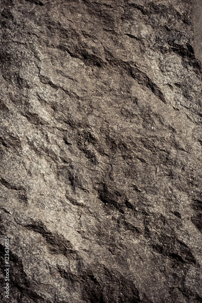 Fototapeta Stone background, rock wall backdrop with rough texture. Abstract, grungy and textured surface of stone material. Nature detail of rocks.