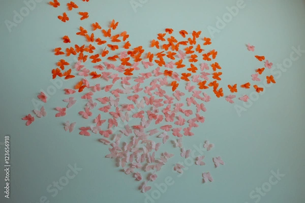 Fototapeta Paper pink rose and red butterflies in form of heart fly on a wall. Valentines day. 14 february