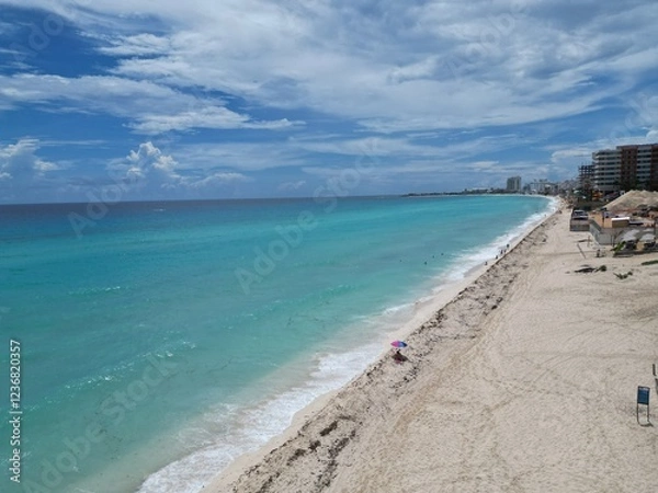 Obraz Aerial Top view of a transparent blue sea with beautiful waves at sunny day in summer. Tropical landscape from the air of ocean with azure water, sandy bottom at sunset. Cancun, Mexico.