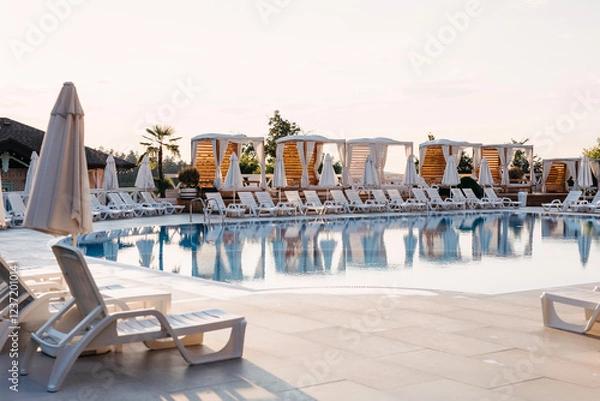 Obraz Luxury poolside resort with lounge chairs