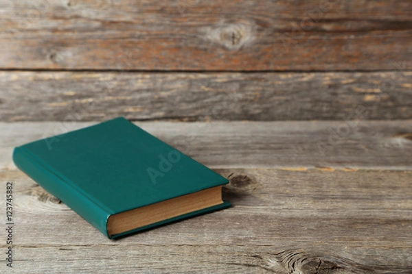 Fototapeta Old book on a grey wooden table