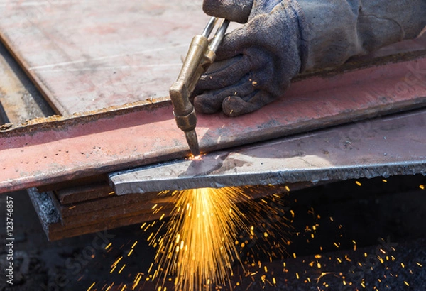 Fototapeta worker cutting steel using metal torch