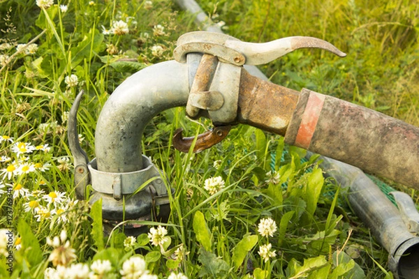 Fototapeta Old rusty hose irrigation