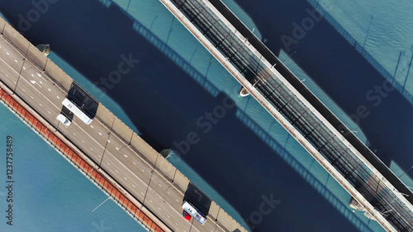 Fototapeta Aerial drone view of bridges across Maas river, railway and automobile road bridge with bicycle lane from above, water background, transportation and infrastructure, Venlo, the Netherlands