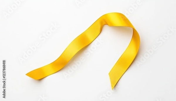 Fototapeta Bright yellow ribbon gracefully draped on a white background, ideal for celebration and gift wrapping