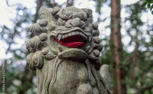 Obraz Close-up selective focus on a Japanese komainu (or lion-dog) statue, near the entrance of a temple in a mountain forest near Ome, Tokyo