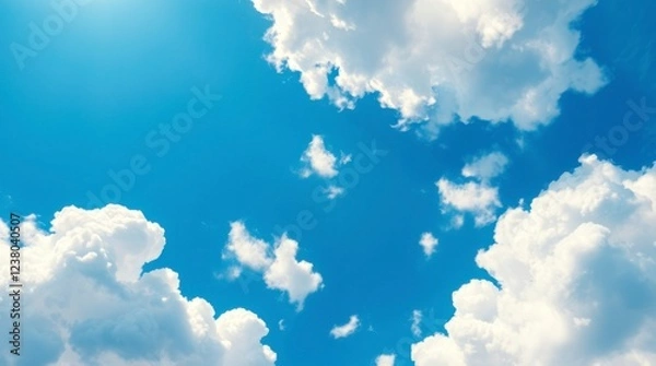Fototapeta Serene Summer Sky: Fluffy White Clouds Drifting Across a Vibrant Blue Canvas