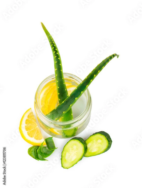 Obraz Herbal set. Aloe Vera in a glass jar, slices of lemon and cucumber. On white, isolated background.