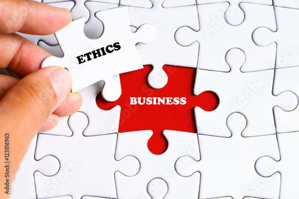 Fototapeta "BUSINESS" word on missing puzzle with a hand hold a piece of "ETHICS" word puzzle want to complete it - business and finance concept