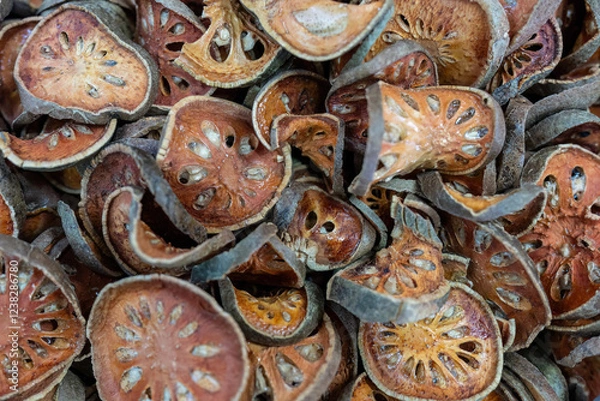 Obraz Dried slices of Bengal quince (also known as golden aple, japanes bitter orange, stone apple or wood apple) at a local market in Thailand. Latin name is Aegle marmelos.
