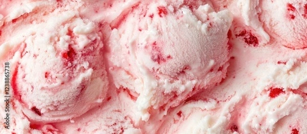 Fototapeta Strawberry ice cream with creamy texture and chunks of strawberry in a swirled pattern on a light background with Copy Space
