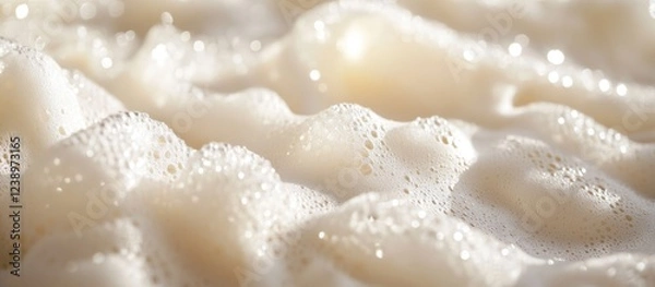 Fototapeta Close-up of soft white foam with bubbles on a smooth surface creating a textured pattern suitable for backgrounds and designs Copy Space