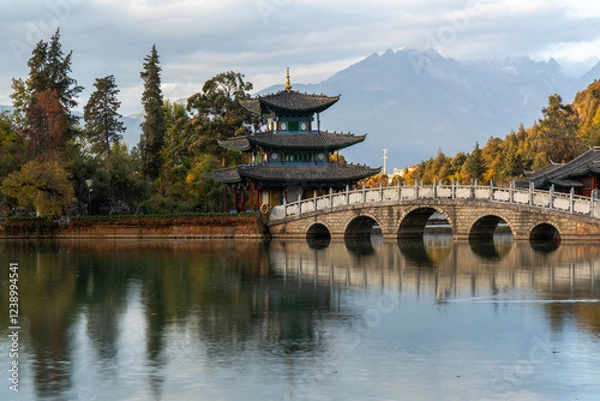Fototapeta Scenic View of Jade Dragon Snow Mountain and Black Dragon Pool with Suocui Bridge and Moon Embracing Pavilion, Lijiang, Yunnan, China