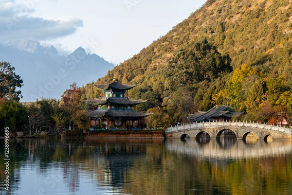 Fototapeta Scenic View of Jade Dragon Snow Mountain and Black Dragon Pool with Suocui Bridge and Moon Embracing Pavilion, Lijiang, Yunnan, China