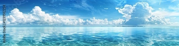 Fototapeta Endless Horizon of Calm Ocean Waters and White Fluffy Clouds Reflecting Above	