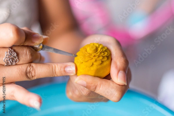 Obraz Woman's hand carved pumpkin flowers.