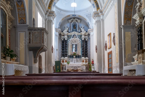 Fototapeta Serene church interior with an ornate altar and rows of wooden pews, creating a peaceful atmosphere.