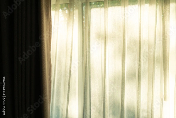 Fototapeta Soft light on curtains window. There was morning light through the window in room, looking at the view of the mountains and trees as the sun rose.